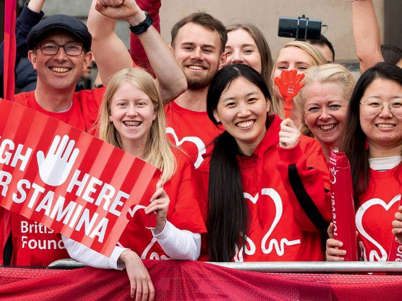 BHF volunteers wearing red BHF t-shirts and cheering.