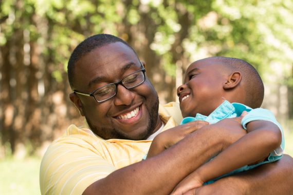 Father and son hugging and smiling