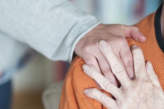 Woman putting a caring hand on a man's shoulder
