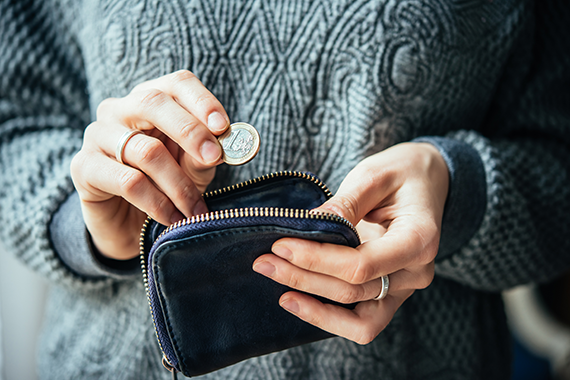 Woman taking a coin from her purse