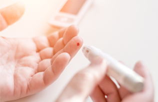 finger prick test for blood glucose in use