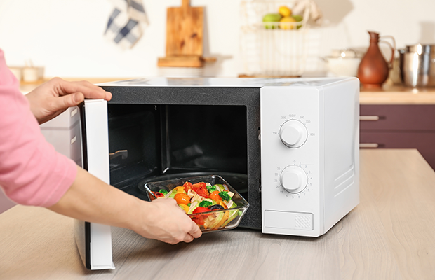 Food being placed into microwave