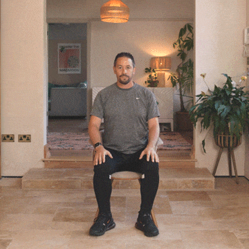 Andrew Scard demonstrates the overhead triceps stretch.