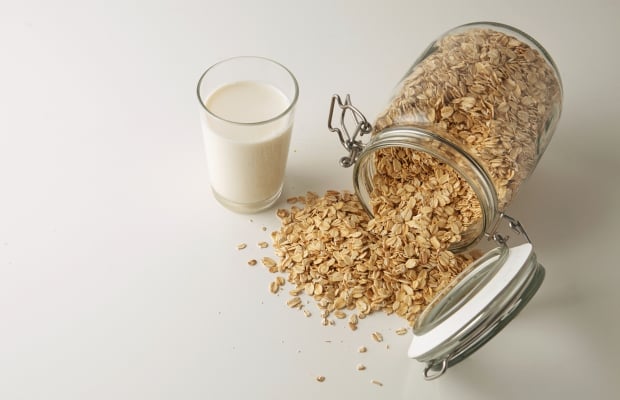 glass of milk and jar of oats