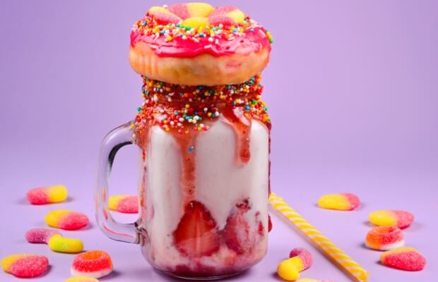 Extreme strawberry freak shake with jelly, donut and sweets